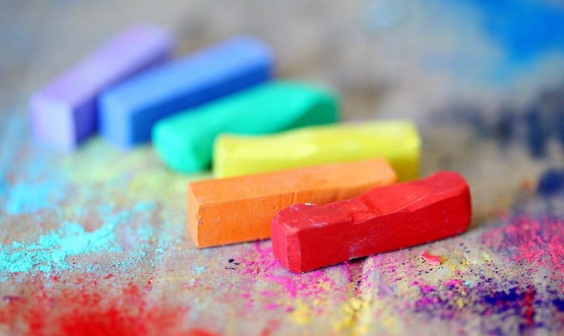 colored bars of chalk in a rainbow line